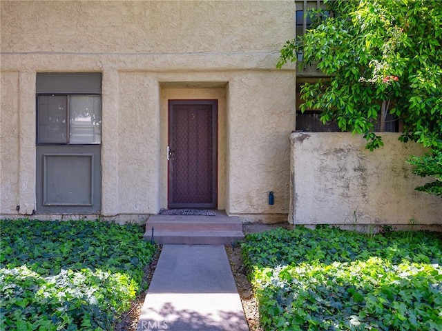 property entrance featuring stucco siding