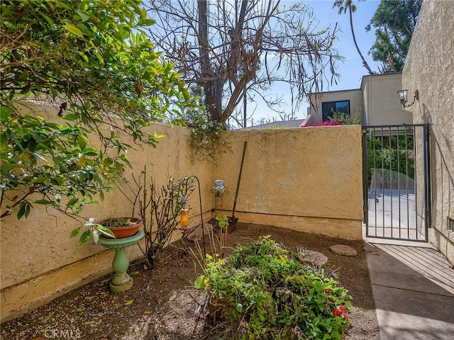 view of yard featuring fence and a gate