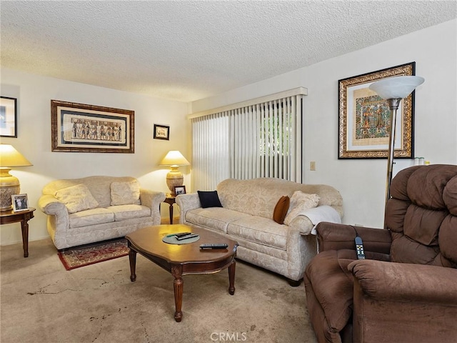 carpeted living room featuring a textured ceiling