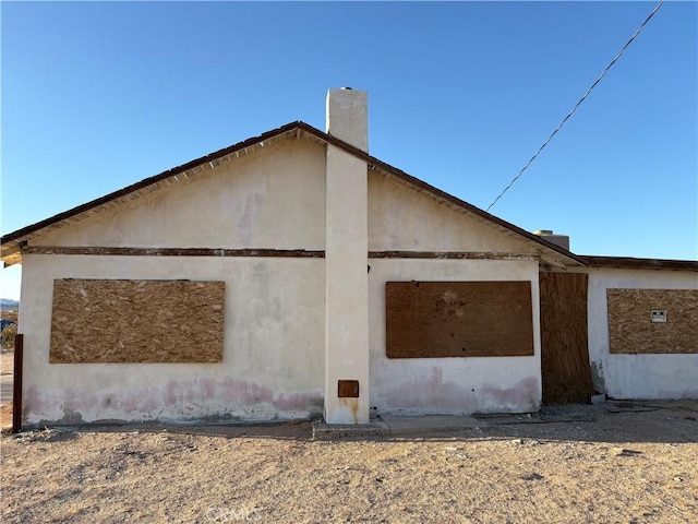 view of home's exterior featuring a chimney