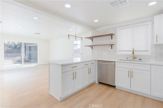 kitchen featuring light wood-style floors, plenty of natural light, a sink, and dishwasher