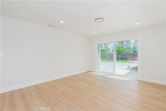 spare room with light wood-style floors, baseboards, recessed lighting, and visible vents