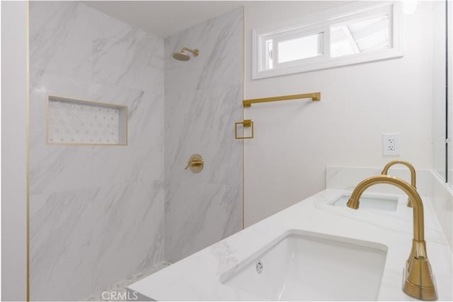 full bathroom with a sink and a marble finish shower