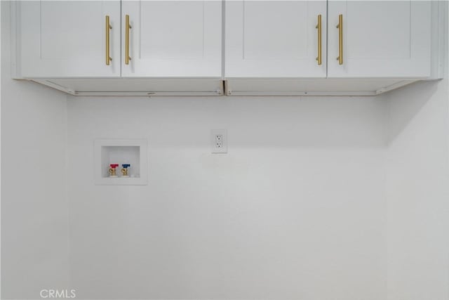 laundry room featuring hookup for a washing machine and cabinet space