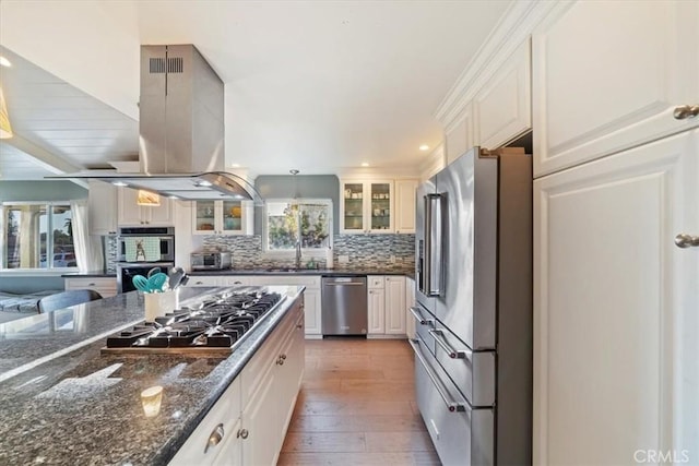 9179 Hidden Farm Rd, Rancho Cucamonga, CA 91737 - kitchen featuring glass insert cabinets, light wood-style flooring, a wealth of natural light, and stainless steel appliances