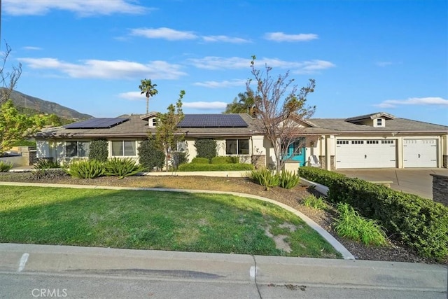 9179 Hidden Farm Rd, Rancho Cucamonga, CA 91737 - single story home featuring a garage, roof mounted solar panels, driveway, and a front yard