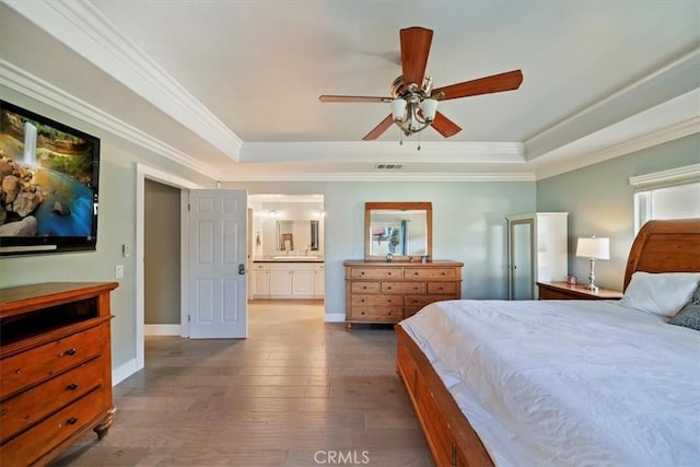 9179 Hidden Farm Rd, Rancho Cucamonga, CA 91737 - bedroom featuring visible vents, ornamental molding, multiple windows, a tray ceiling, and hardwood / wood-style flooring