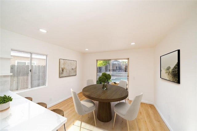 dining space featuring recessed lighting, baseboards, and light wood-style floors