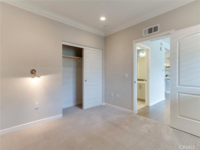 unfurnished bedroom with crown molding, baseboards, carpet, and visible vents