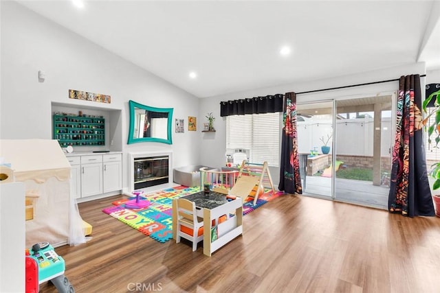 28582 Sand Island Way, Menifee, CA 92584 - game room with recessed lighting, a fireplace with flush hearth, light wood-style flooring, and lofted ceiling