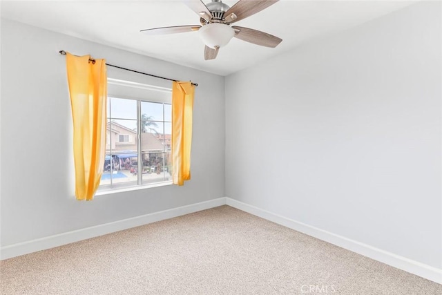 spare room with baseboards, ceiling fan, and carpet flooring