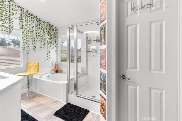 full bathroom featuring a garden tub, vanity, and a shower stall