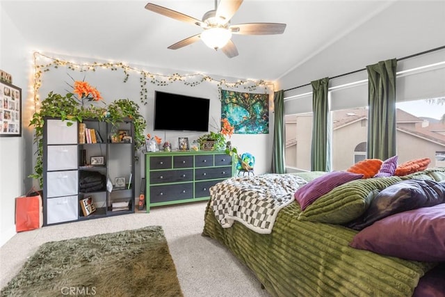 bedroom featuring carpet, a ceiling fan, and lofted ceiling