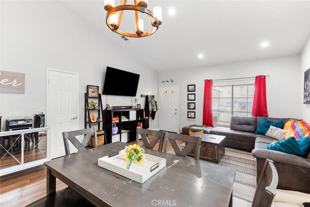 living room featuring recessed lighting, wood finished floors, a notable chandelier, and high vaulted ceiling