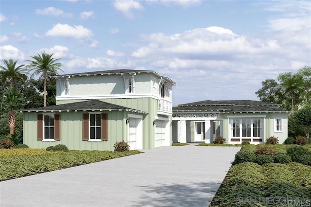 view of front facade featuring board and batten siding, an attached garage, and concrete driveway