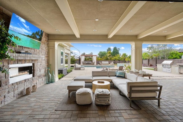 956 Urania Ave, Encinitas, CA 92024 - view of patio with exterior kitchen, a fenced backyard, grilling area, and an outdoor living space with a fireplace