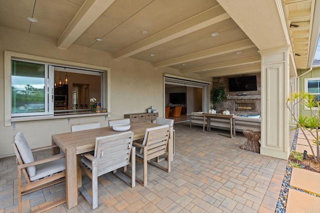 956 Urania Ave, Encinitas, CA 92024 - view of patio featuring a warm lit fireplace and outdoor dining area