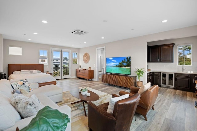 956 Urania Ave, Encinitas, CA 92024 - living room featuring beverage cooler, light wood-style floors, recessed lighting, and bar