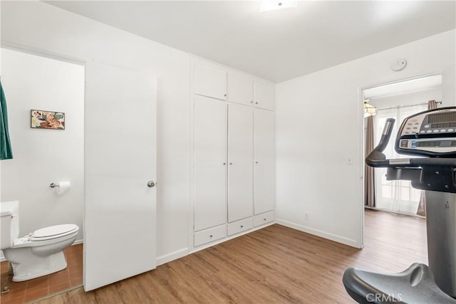 interior space featuring baseboards and wood finished floors