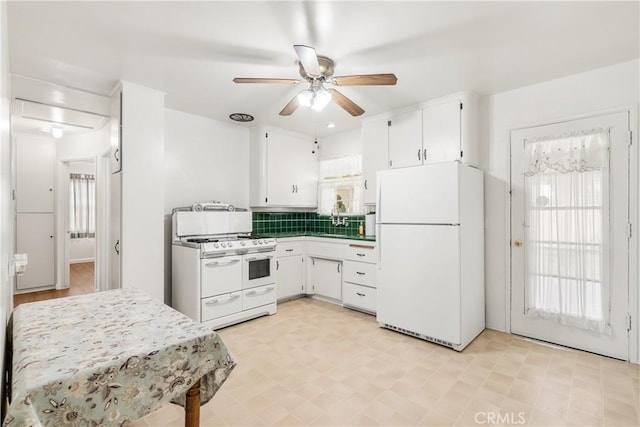 kitchen featuring ceiling fan, dark countertops, white appliances, white cabinetry, and tasteful backsplash