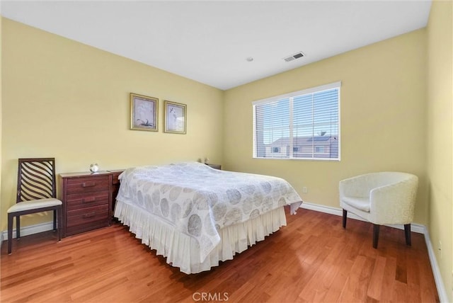 11913 Solitaire Ct, Jurupa Valley, CA 91752 - bedroom featuring baseboards, wood finished floors, and visible vents
