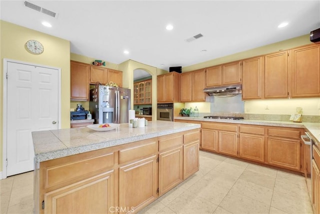 kitchen with visible vents, tile countertops, appliances with stainless steel finishes, and under cabinet range hood