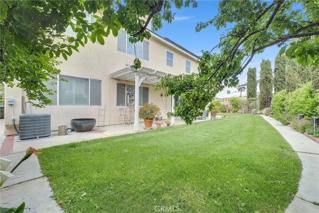 rear view of property featuring a pergola, central AC, stucco siding, a patio area, and a yard