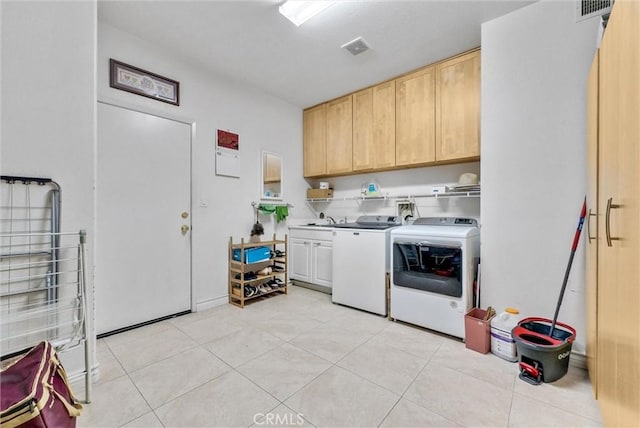laundry area with cabinet space, separate washer and dryer, visible vents, and light tile patterned flooring