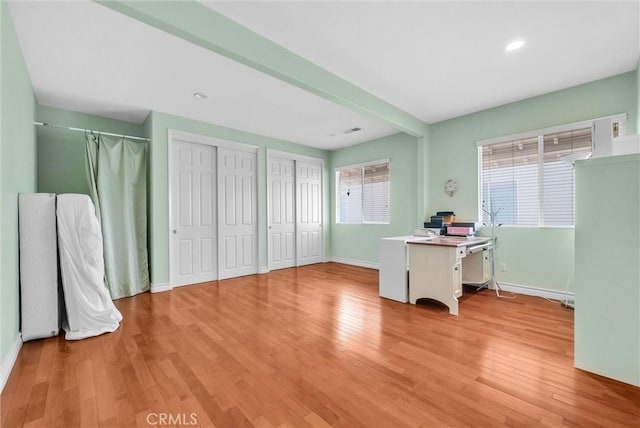 office featuring recessed lighting, baseboards, a wealth of natural light, and light wood-style flooring