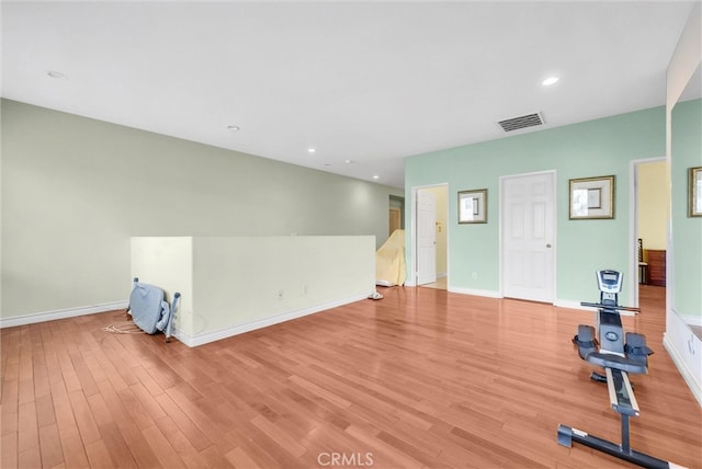 exercise room with visible vents, recessed lighting, light wood finished floors, and baseboards