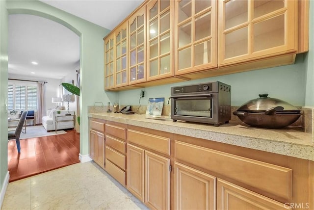 bar with a toaster, arched walkways, baseboards, and recessed lighting