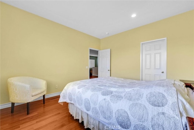 bedroom with baseboards, recessed lighting, and wood finished floors