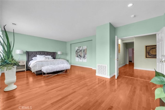 bedroom featuring recessed lighting, baseboards, visible vents, and wood finished floors