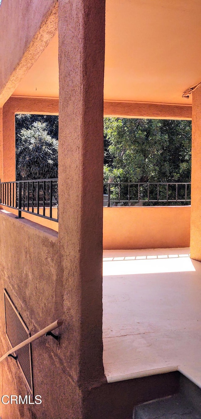 view of patio featuring a balcony