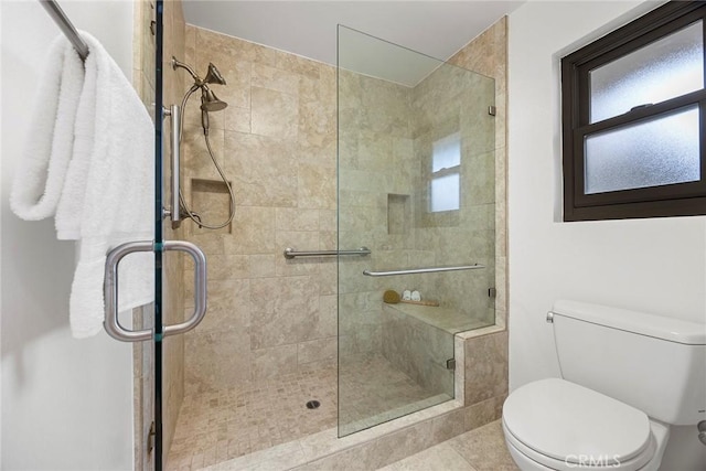 full bath featuring a stall shower and toilet