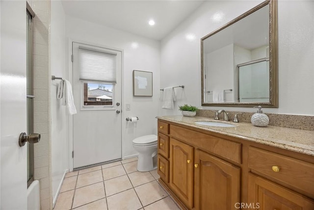 full bath with toilet, combined bath / shower with glass door, tile patterned flooring, and vanity