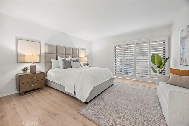 bedroom featuring baseboards and wood finished floors