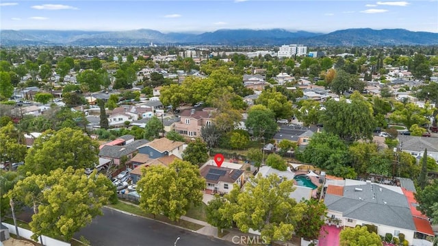 drone / aerial view featuring a residential view and a mountain view