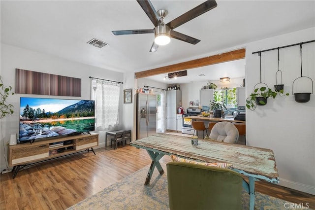 dining room featuring visible vents, a ceiling fan, a healthy amount of sunlight, and light wood-type flooring