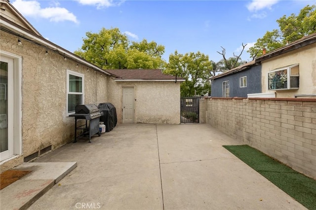 view of patio featuring a gate, fence, and area for grilling