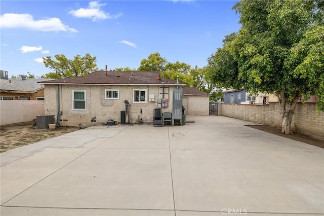 back of property featuring central air condition unit, a patio, a fenced backyard, and stucco siding