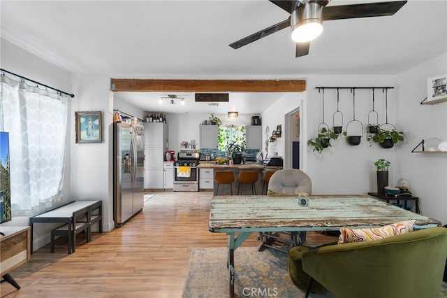 living room featuring ceiling fan and light wood finished floors