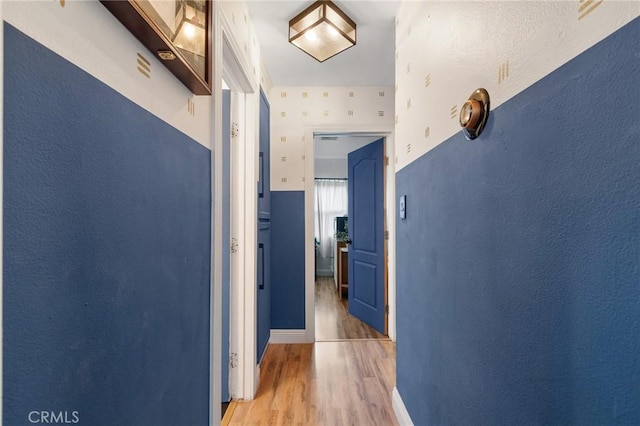 corridor with light wood-style floors