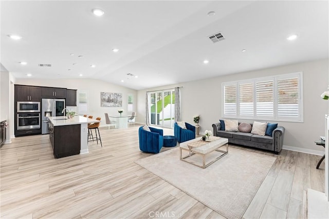 2710 Santa Fiora Dr, Corona, CA 92882 - living room with visible vents, baseboards, lofted ceiling, and light wood-type flooring