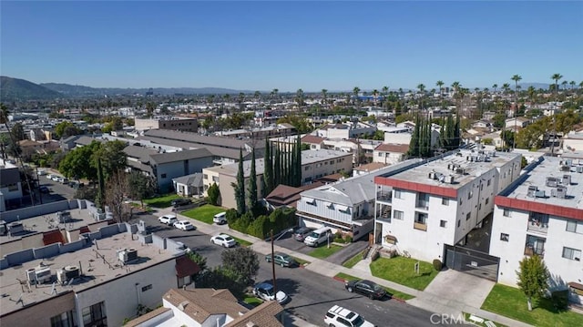 birds eye view of property with a mountain view