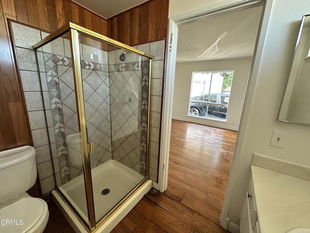 full bathroom featuring vanity, a shower stall, toilet, and wood finished floors