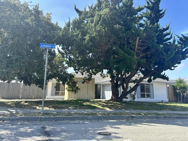 view of front facade with a garage and fence