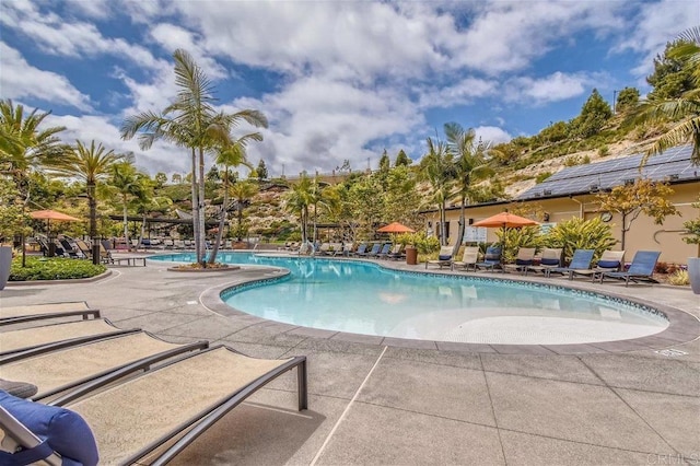 community pool featuring a patio area