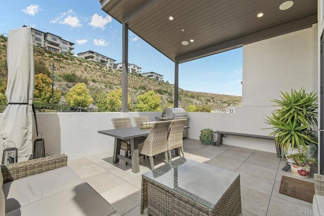 view of patio / terrace with grilling area, an outdoor kitchen, and outdoor dining area