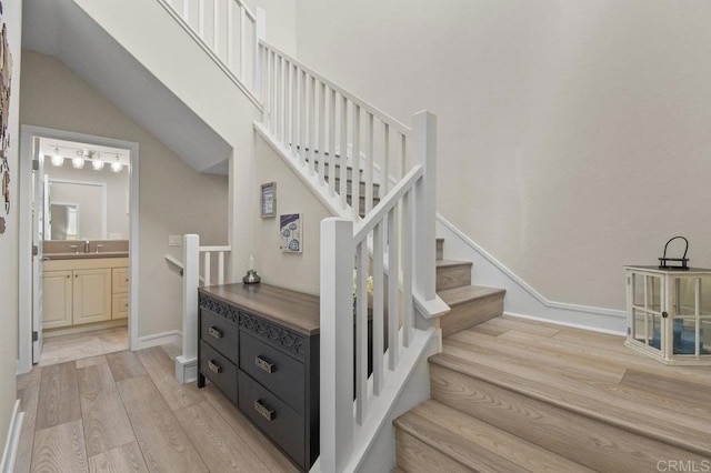 stairway featuring baseboards and wood finished floors